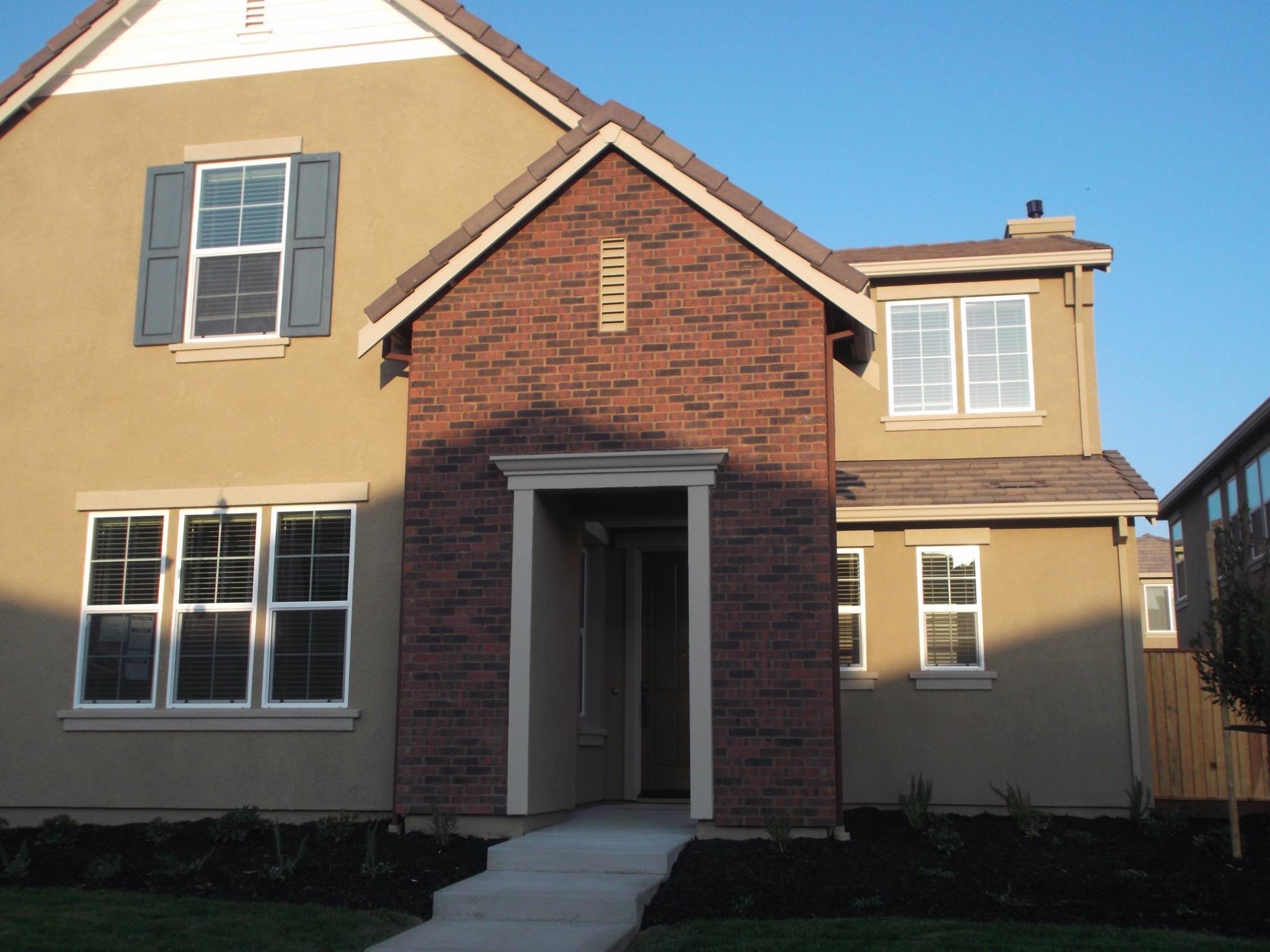 Brick facade around the front entry of a two-story home